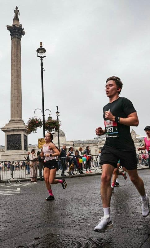 Alex running past Nelson's Column during a marathon.