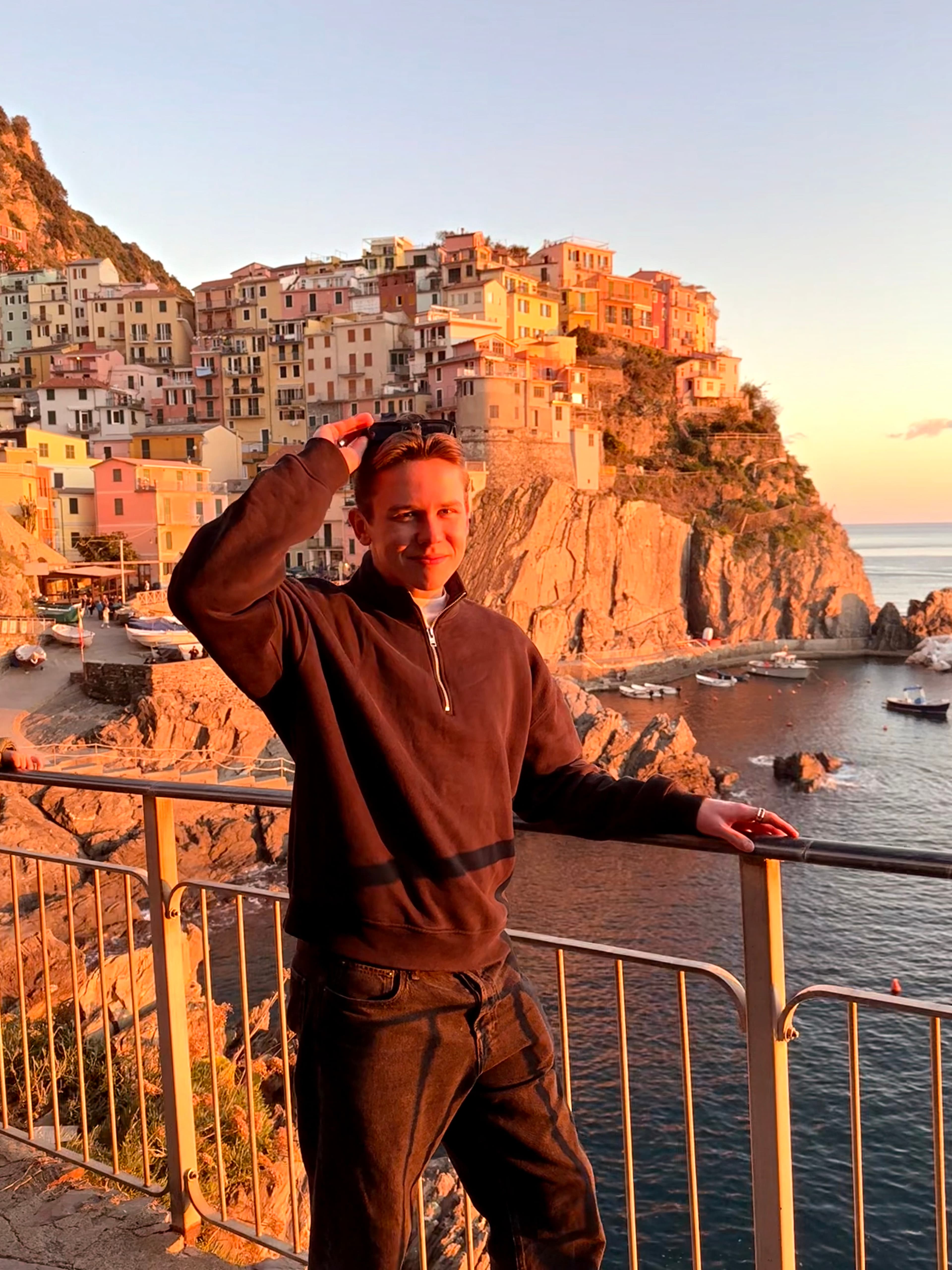Alex at a cliffside coastal village in Italy at sunset.
