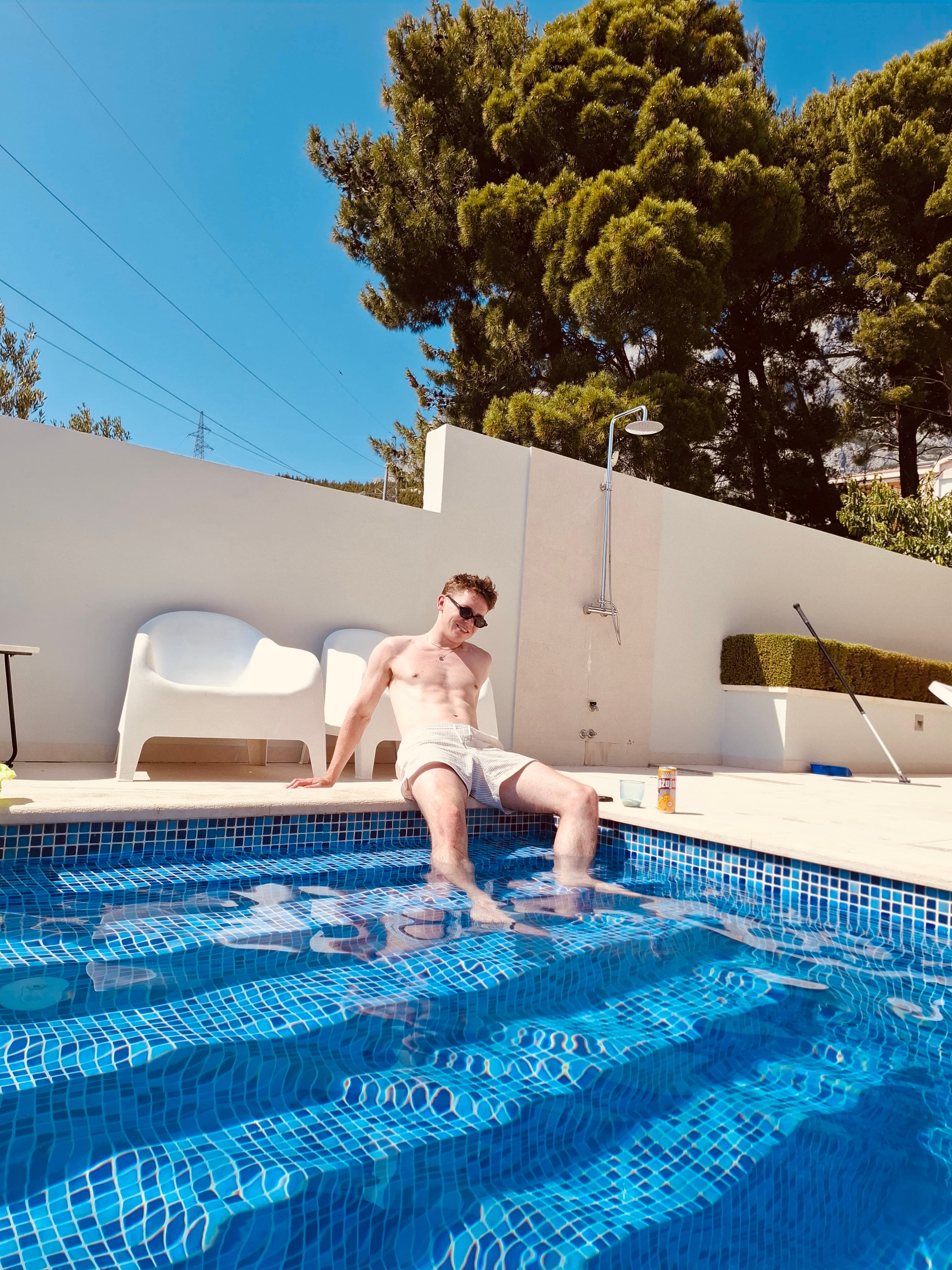 Relaxing by a pool on a warm travel day.