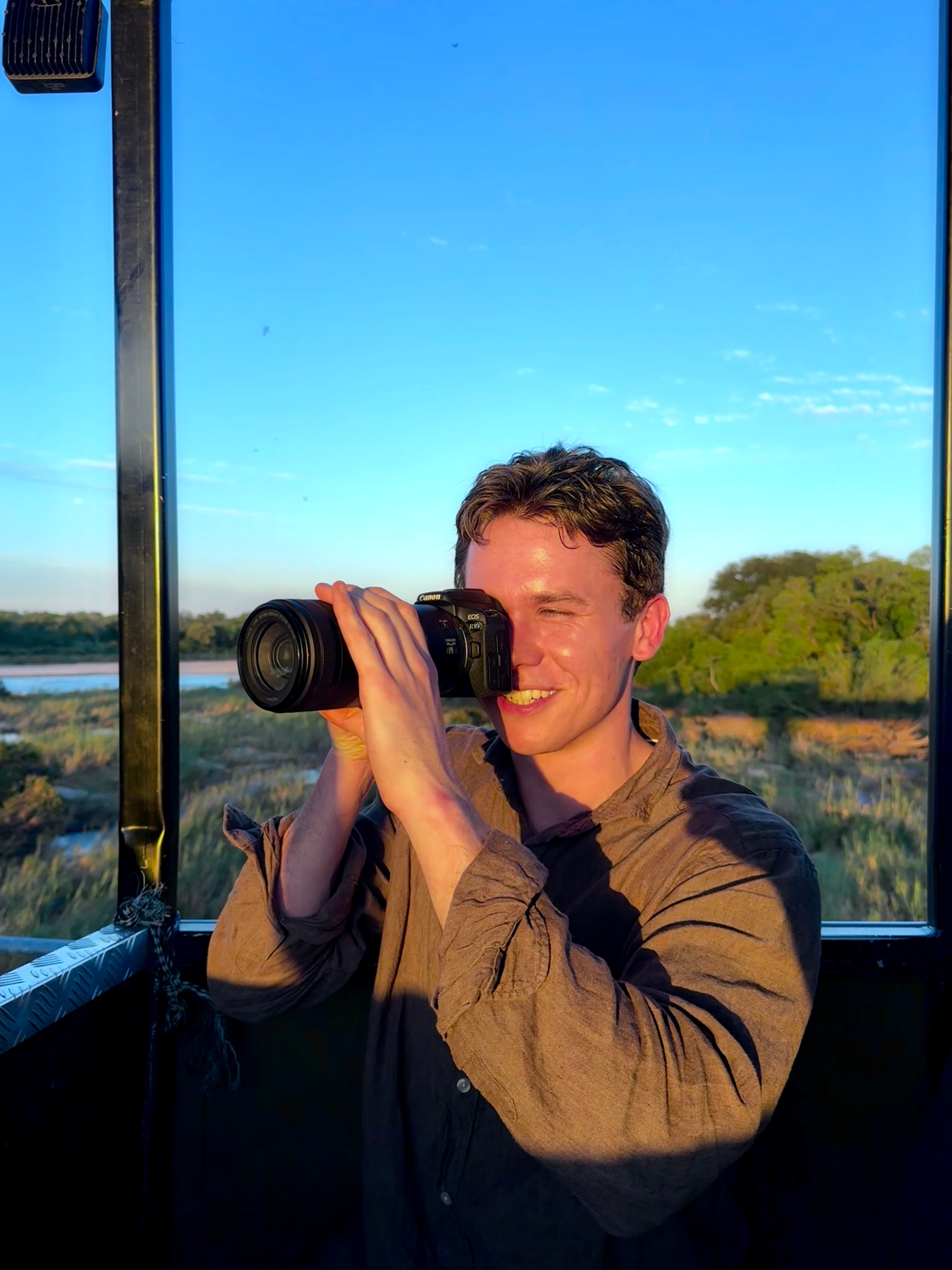 Alex using a camera during safari.